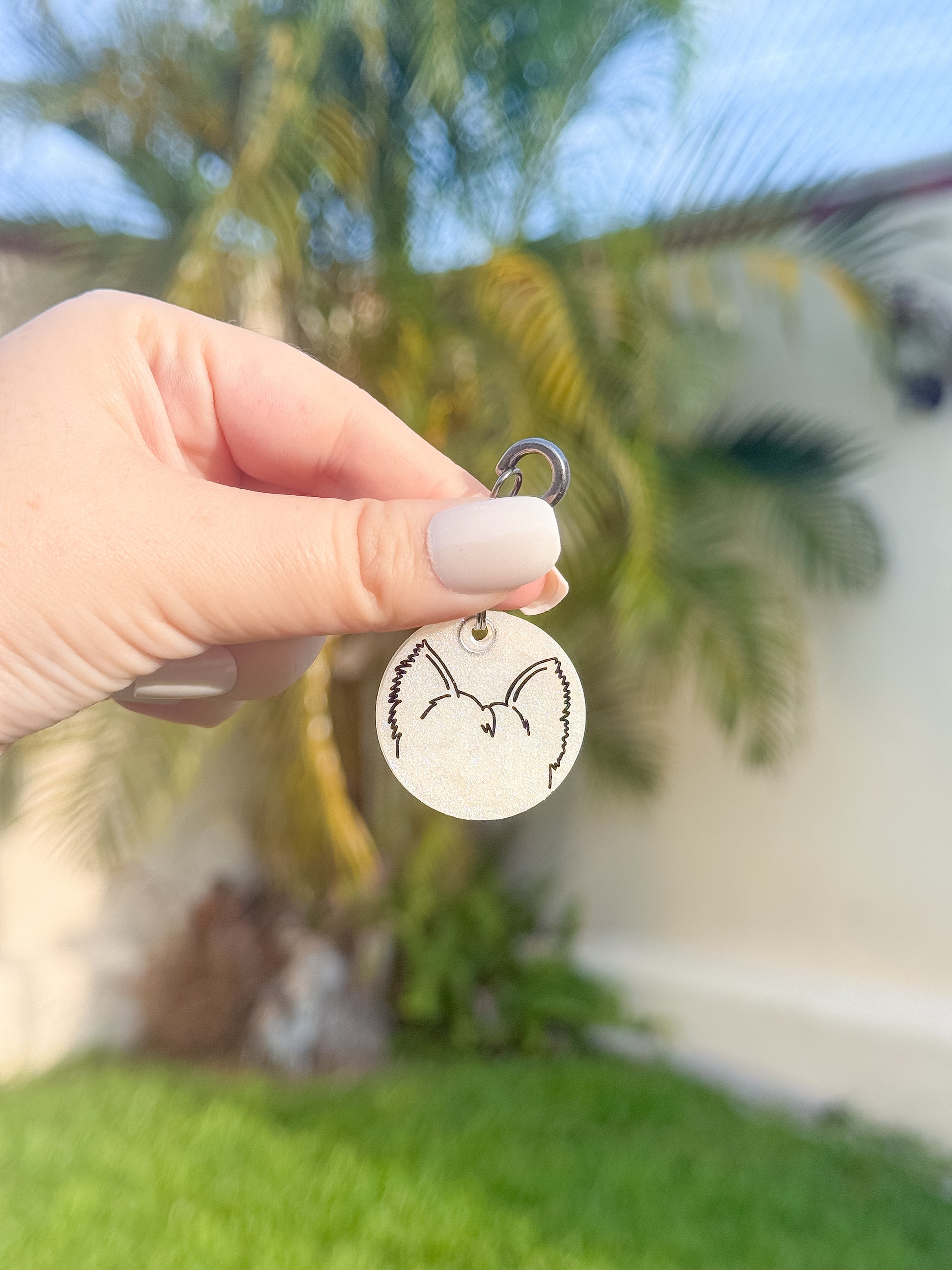 Placa redonda con ilustración de orejas perrito en blanco y negro, estilo minimalista y tierno.