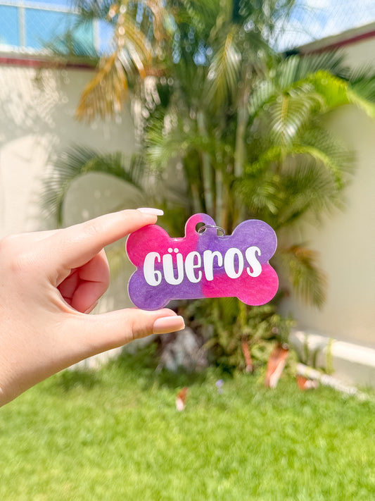 Etiqueta personalizada para jaula color rosa con glitter y nombre Güeros. Diseño llamativo y funcional.