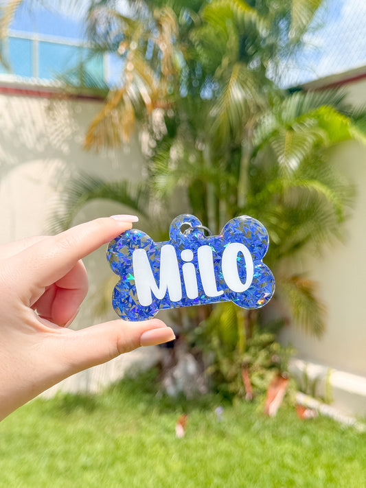 Etiqueta decorativa para jaula de mascota, diseño azul con glitter y nombre Milo.