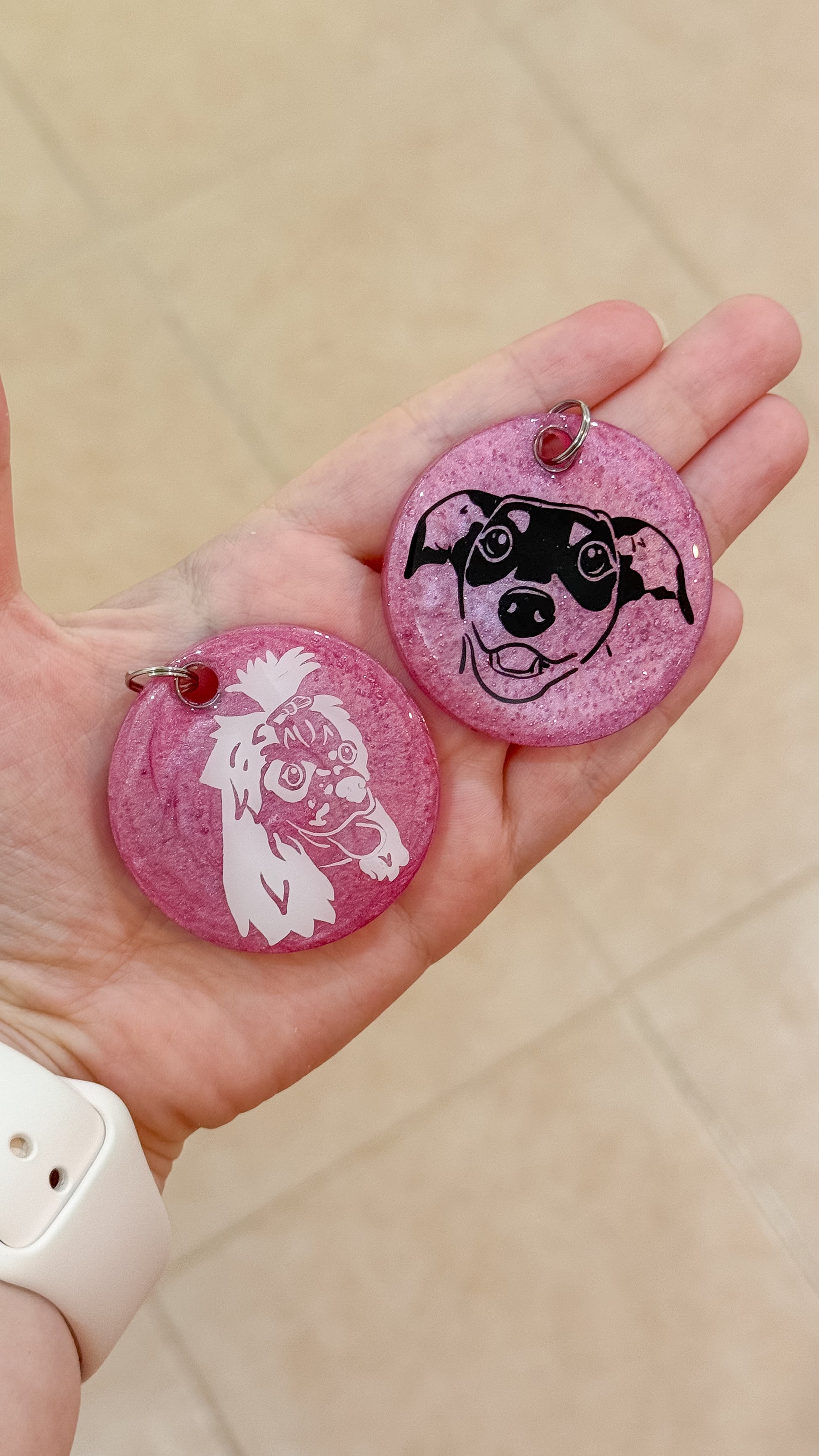 Placas redondas color rosa con ilustraciones de caritas de perros. Estilo artístico y femenino.