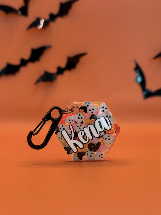 Placa con nombre “Kena” en fondo naranja y negro, diseño otoñal ideal para la temporada.