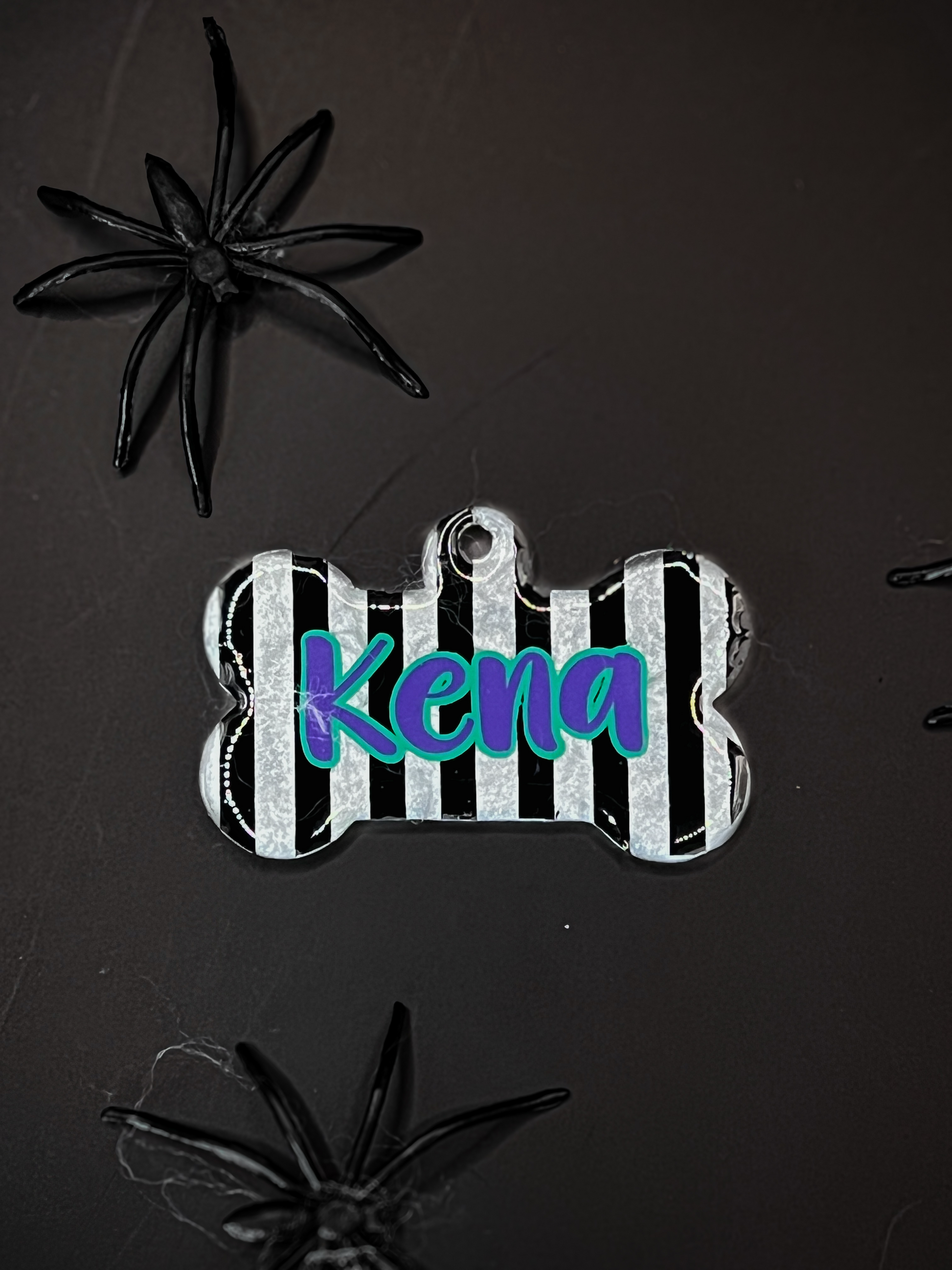 Placa estilo zebra con nombre Kena. Accesorio con temática de Halloween